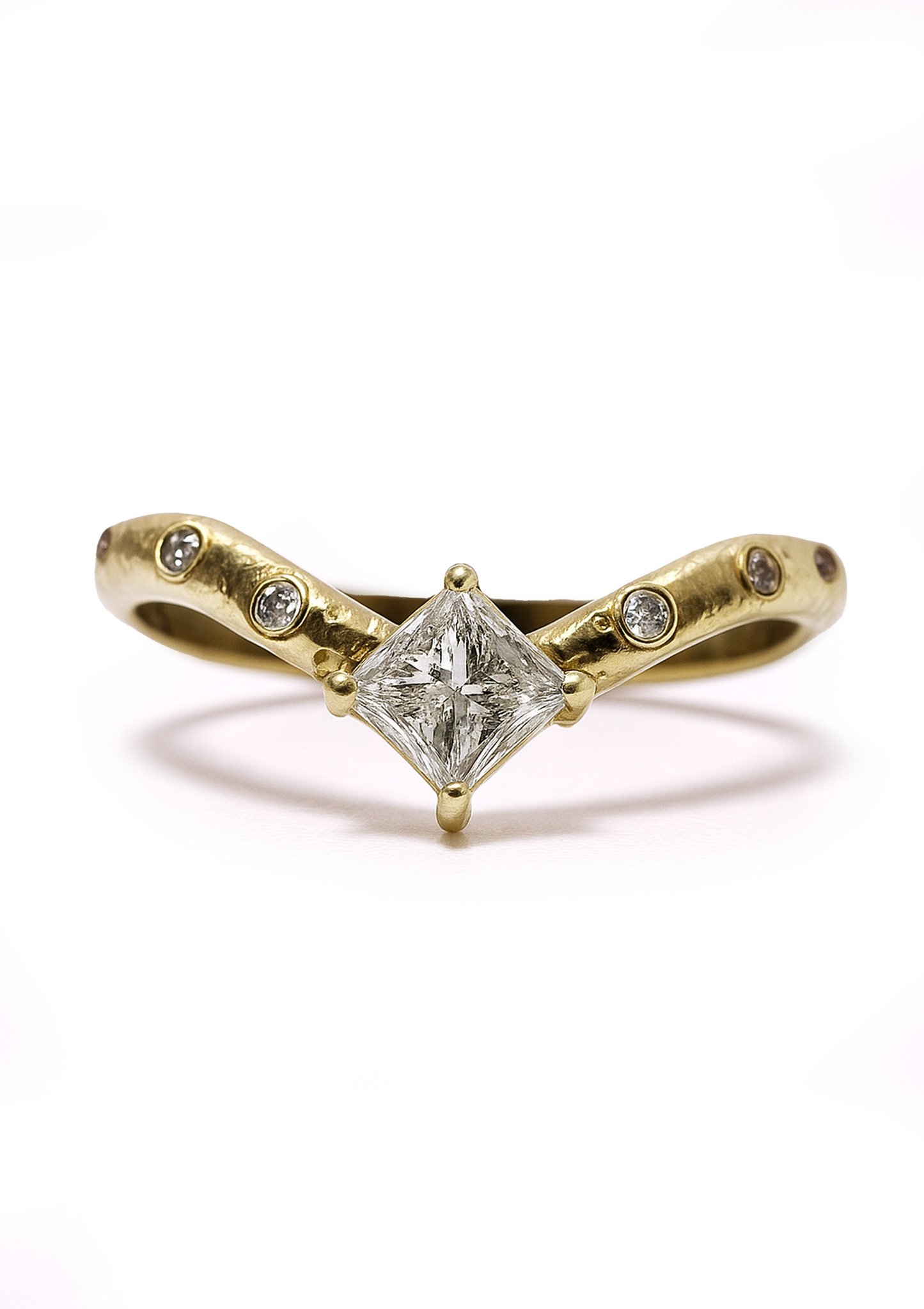 Gold ring with a central diamond and smaller diamonds on a white background